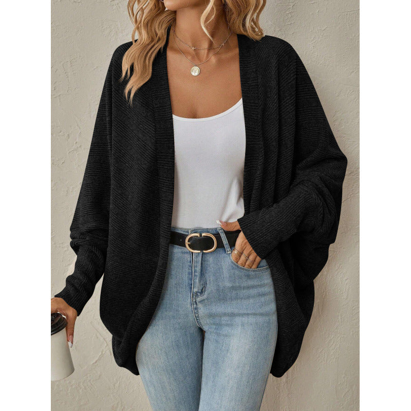 Black oversized open front cardigan styled with a white tank and jeans