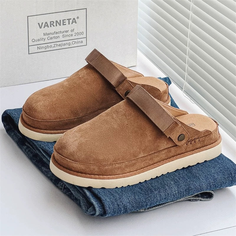 Women’s chestnut brown fleece lined cork sandals with Velcro strap on folded jeans