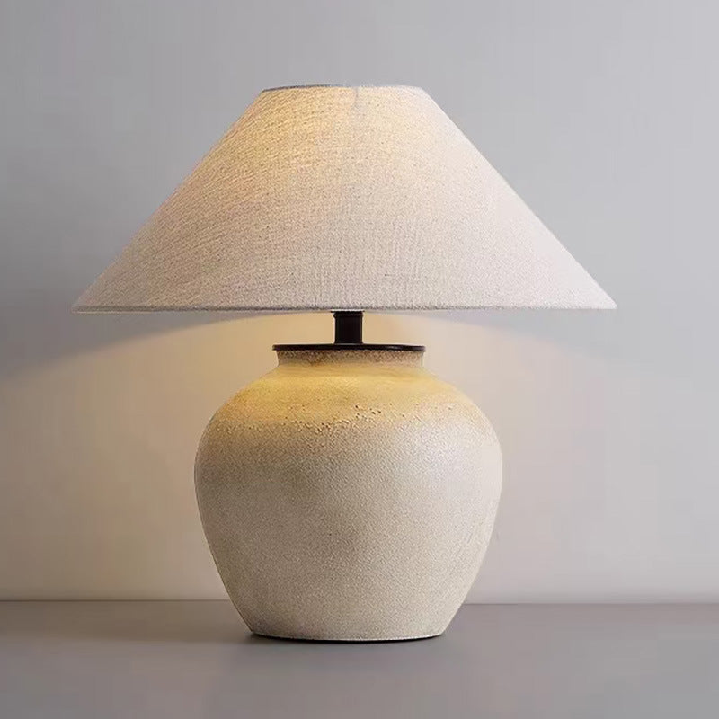 Vintage Japanese retro ceramic table lamp in beige with fabric shade on tabletop, front view.