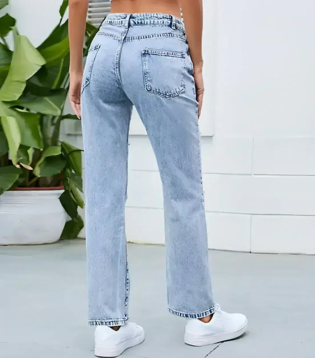 Women’s light blue straight-leg jeans back view showing relaxed fit and clean washed denim finish