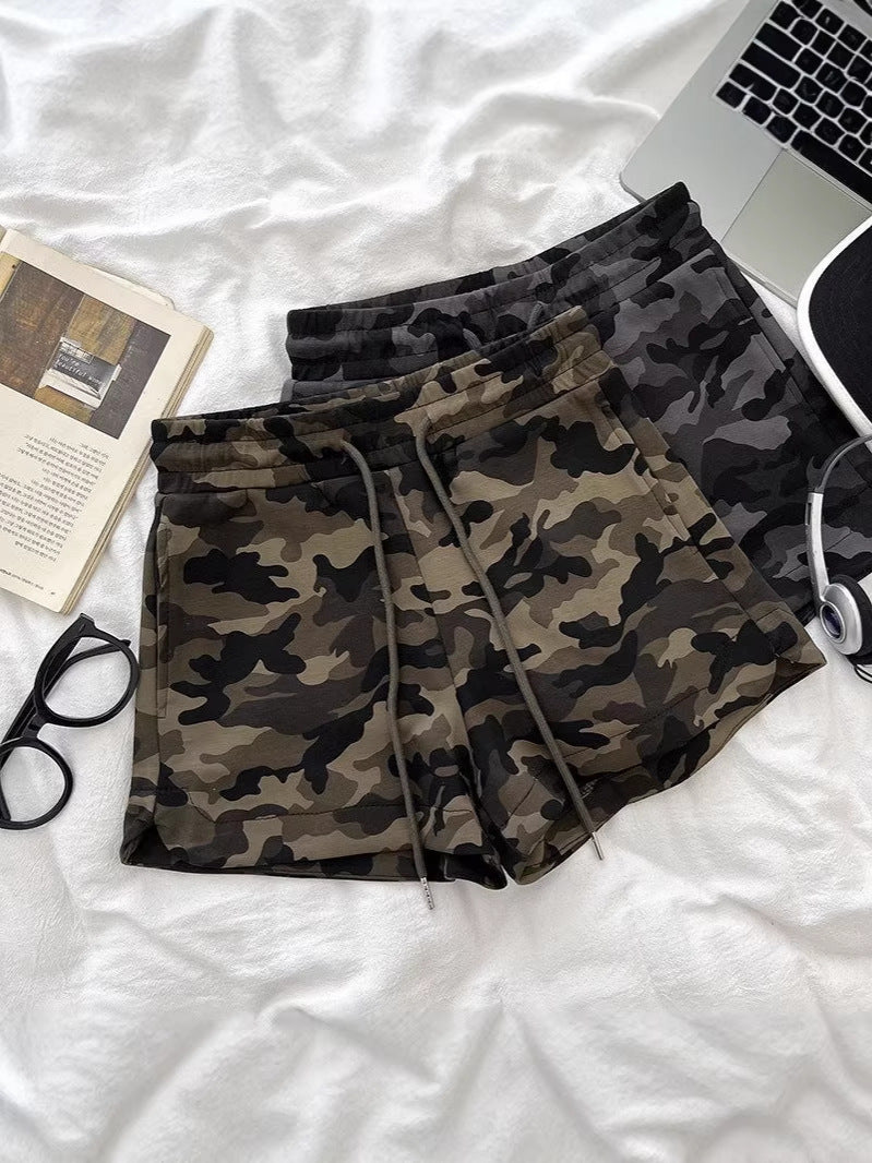 Women's high-waisted camo shorts in army green - front view