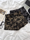 Women's high-waisted camo shorts in army green - front view