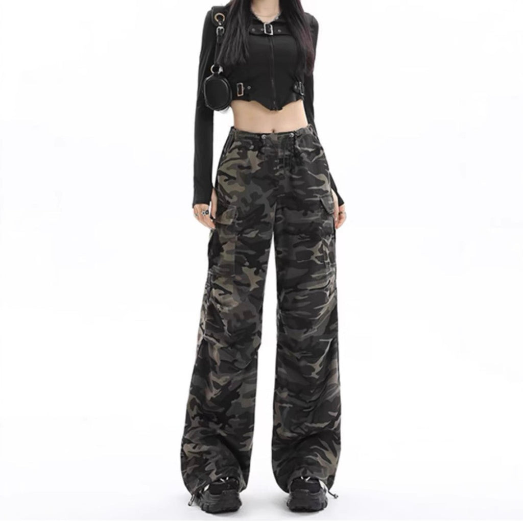 Camouflage cargo pants styled with black crop top, full length standing view
