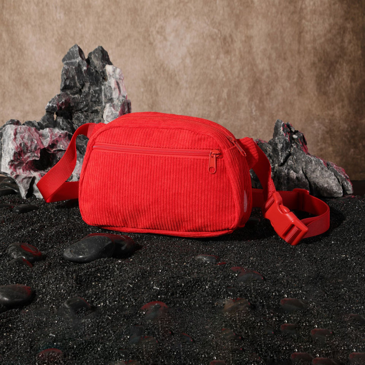 Red corduroy dog walking waist bag with front zip pocket and buckle strap, side view