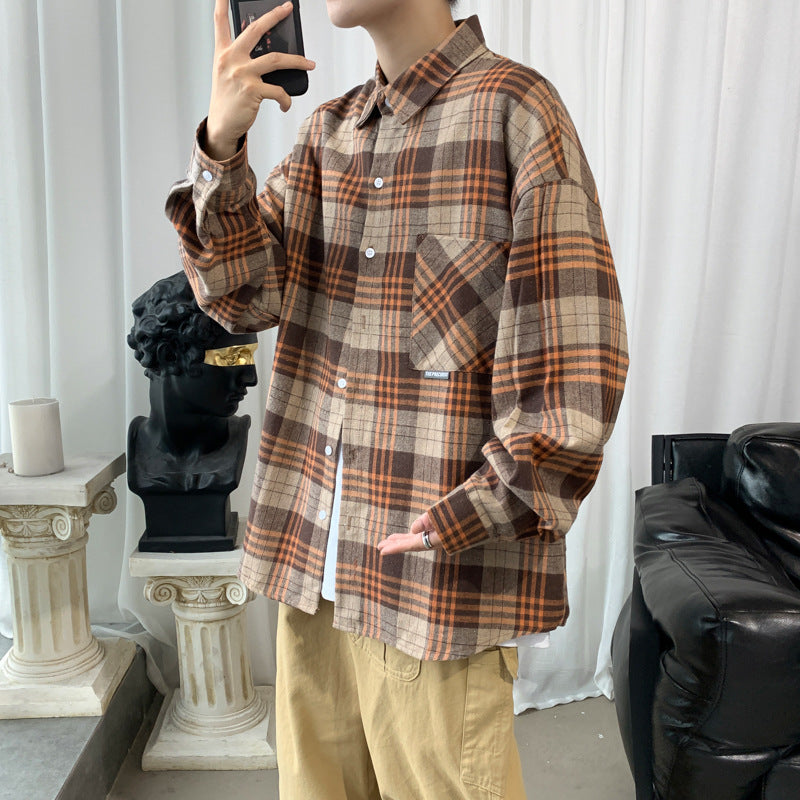 Men's khaki and orange plaid oversized flannel shirt jacket with chest pocket, styled with khaki pants