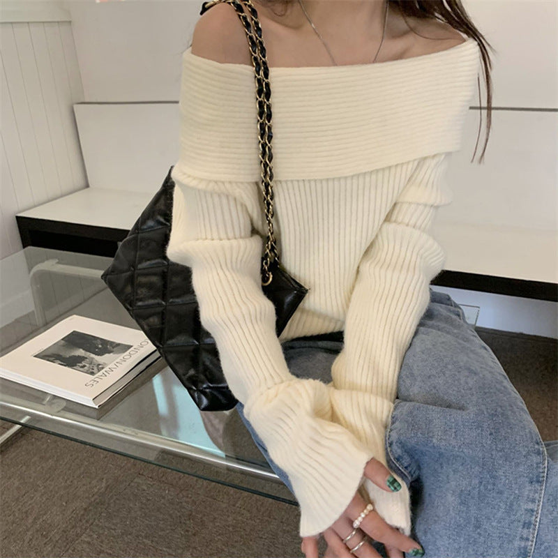 Cream fold over off the shoulder sweater in ribbed knit styled with jeans and a black quilted chain-strap bag