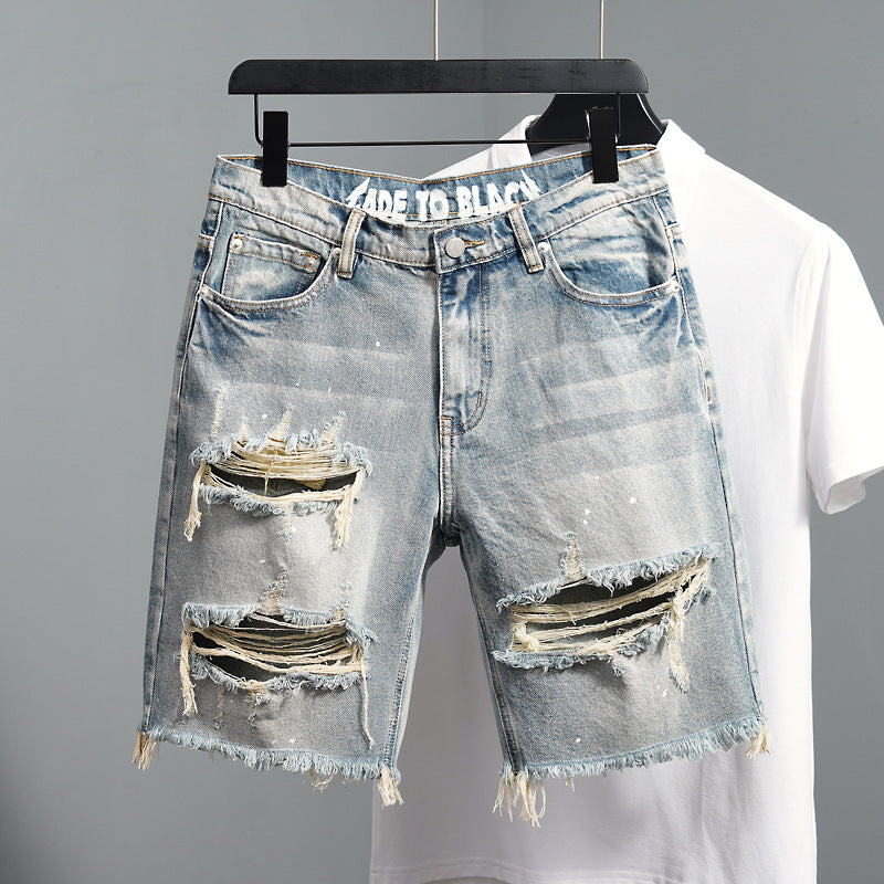 Men's distressed denim shorts straight fit hanging on white tee