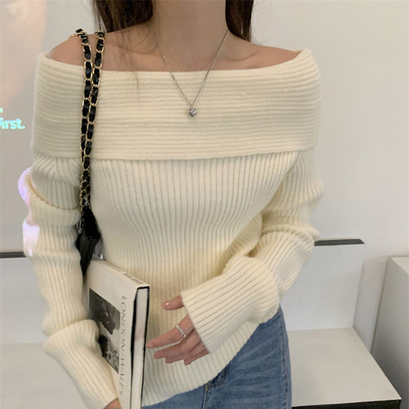 Close-up of cream ribbed fold over off shoulder sweater with a wide folded neckline and long sleeves