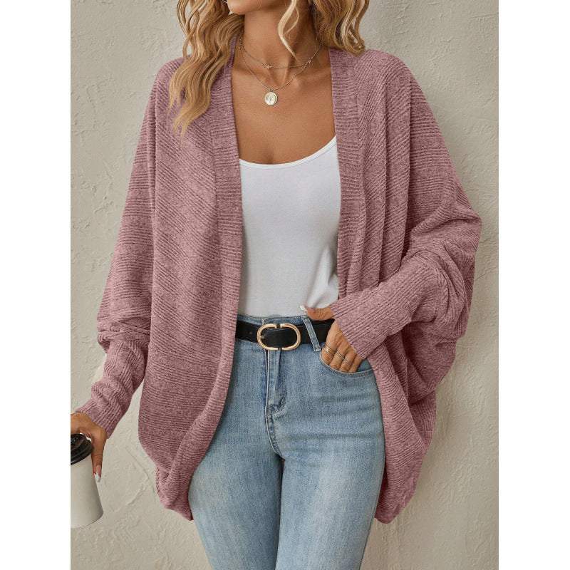 Pink oversized open front cardigan styled with a white tank and jeans
