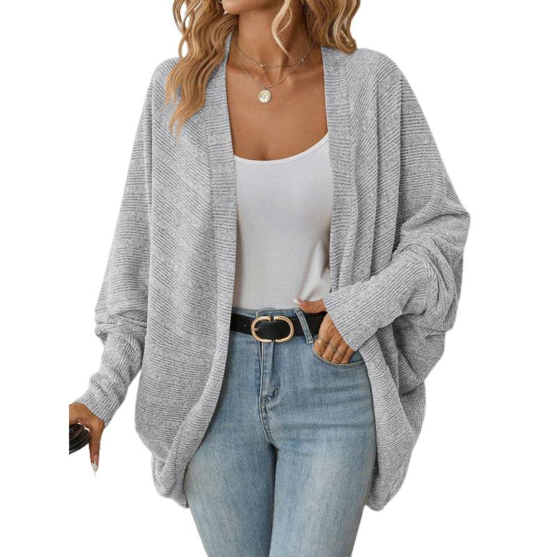 Gray oversized open front cardigan styled with a white tank and jeans