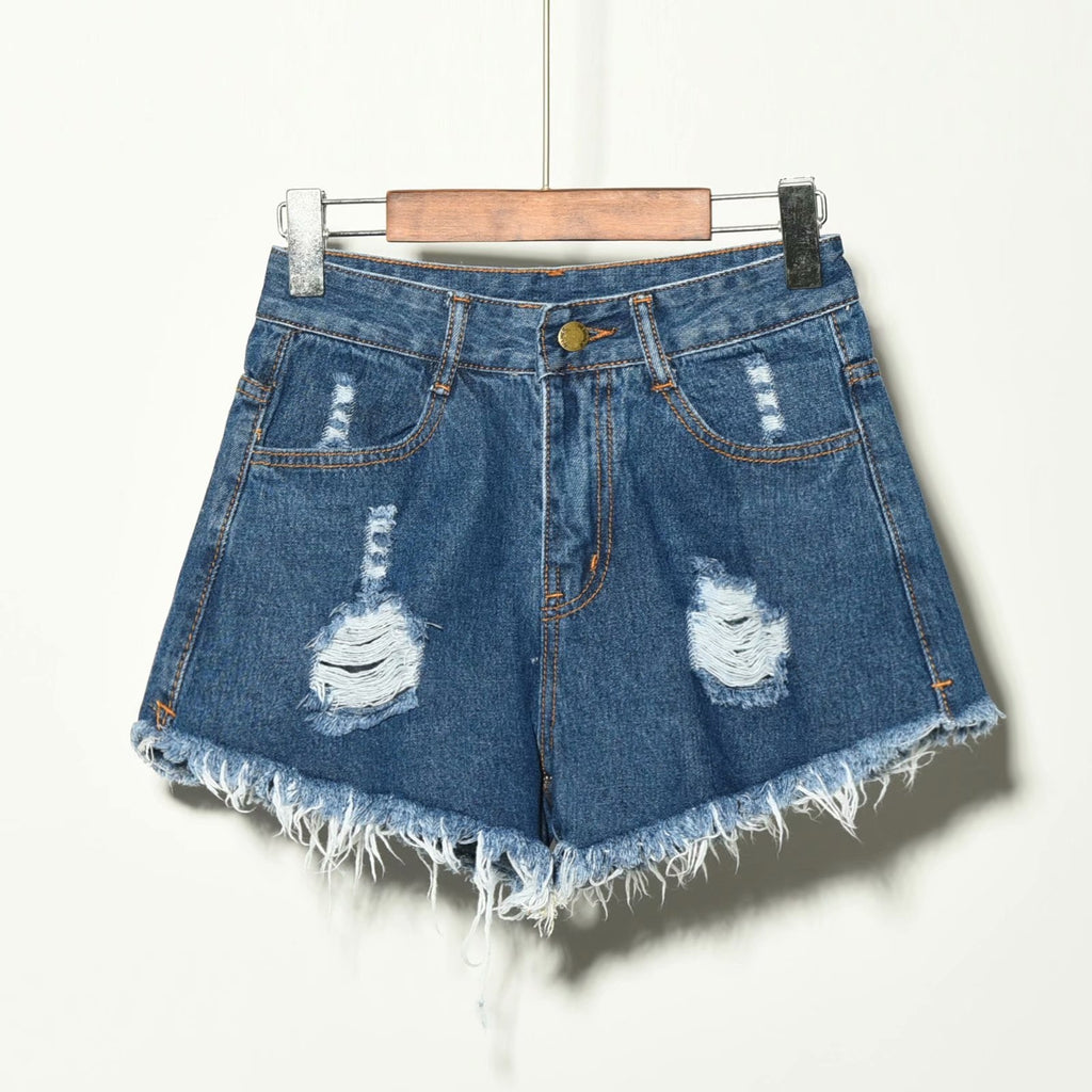 Blue high waisted wide leg ripped denim shorts women with distressed details and raw frayed hem on wooden hanger