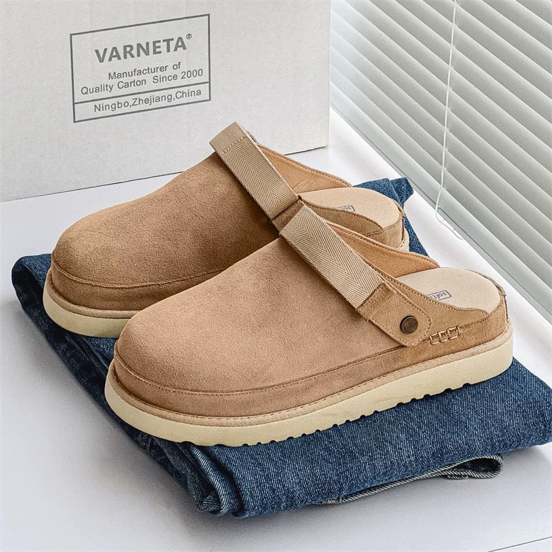 Women’s tan fleece lined cork sandals with adjustable Velcro strap displayed on blue jeans