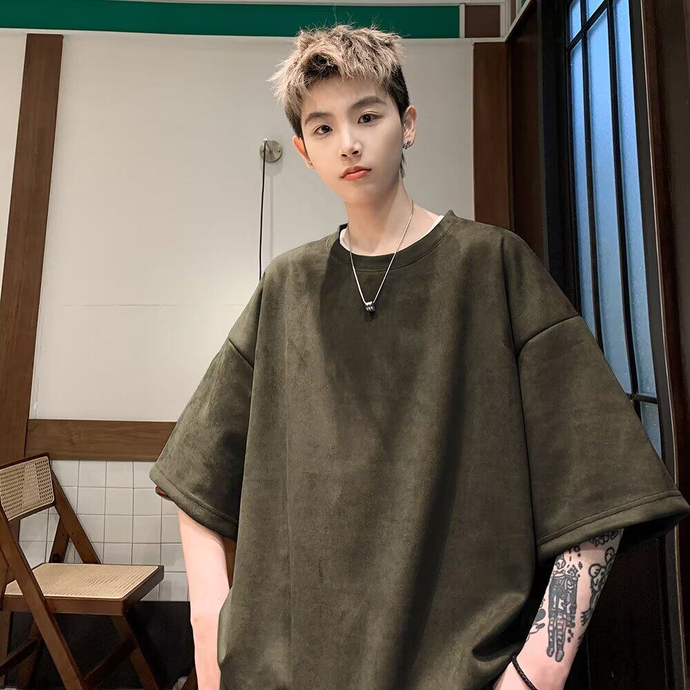 Dark grayish olive suede T-shirt back view large ECHHERE print, model in casual indoor pose