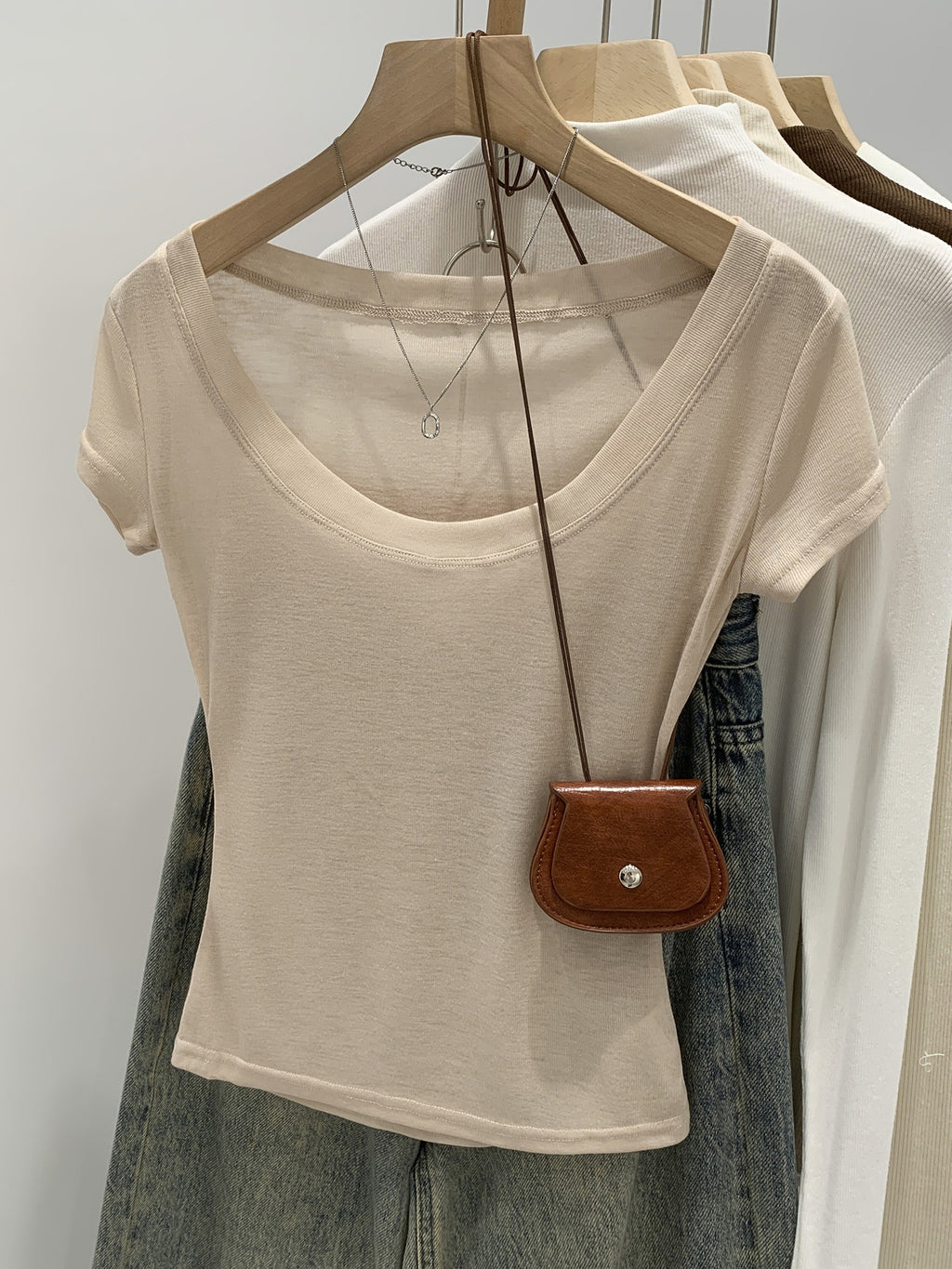 Orange pink women's scoop neck t-shirt, close-up of neckline
