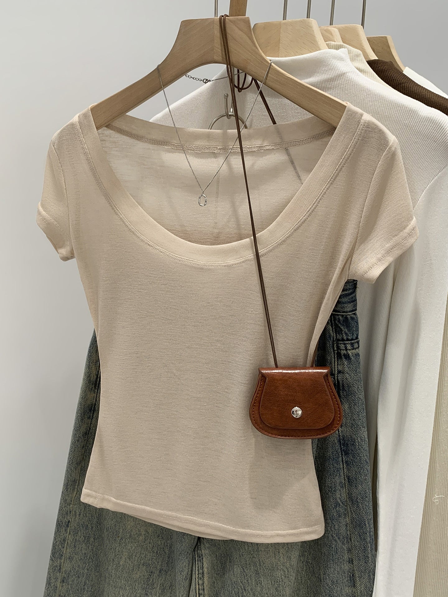 Orange pink women's scoop neck t-shirt, close-up of neckline