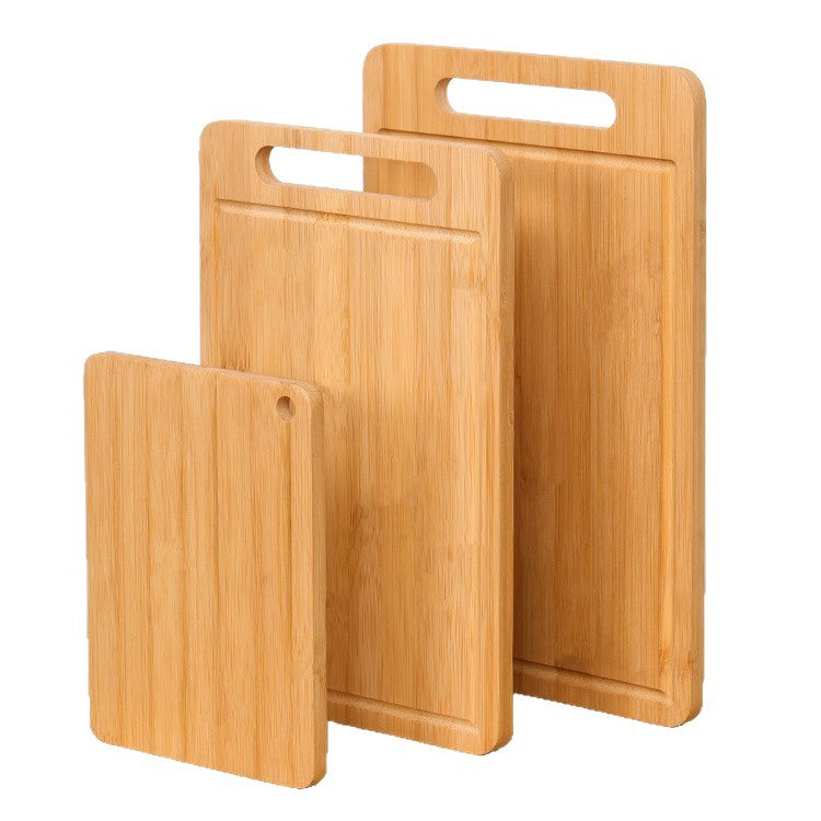 Another view of a set of three varying-sized bamboo cutting boards with handles, stacked neatly and shown from an angled perspective.