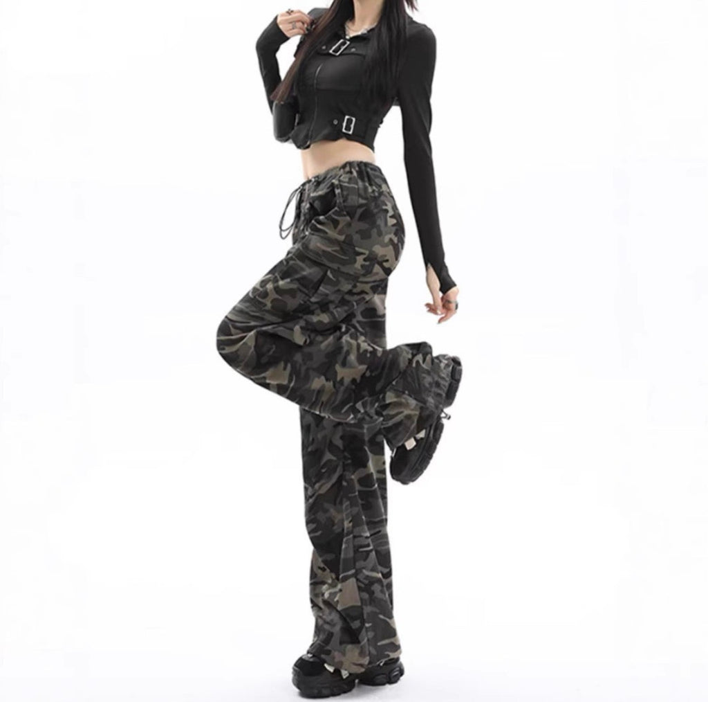 Camo cargo pants side pose styled with black crop top and boots