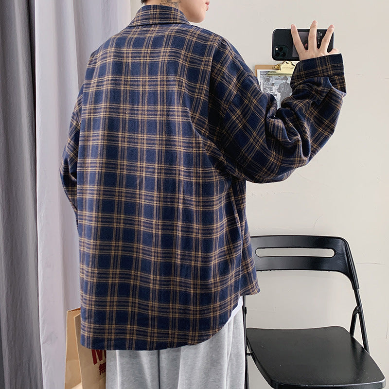 Back view of a navy blue oversized flannel plaid shirt jacket on a man