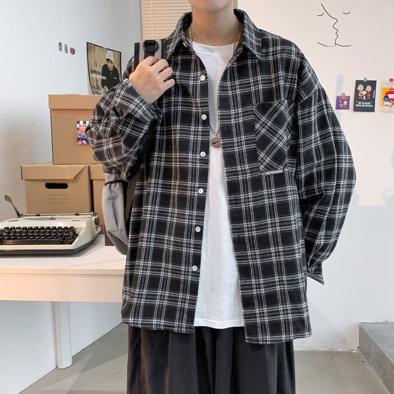 Men's black and gray plaid flannel shacket, loose fit long sleeve, worn over a white tee