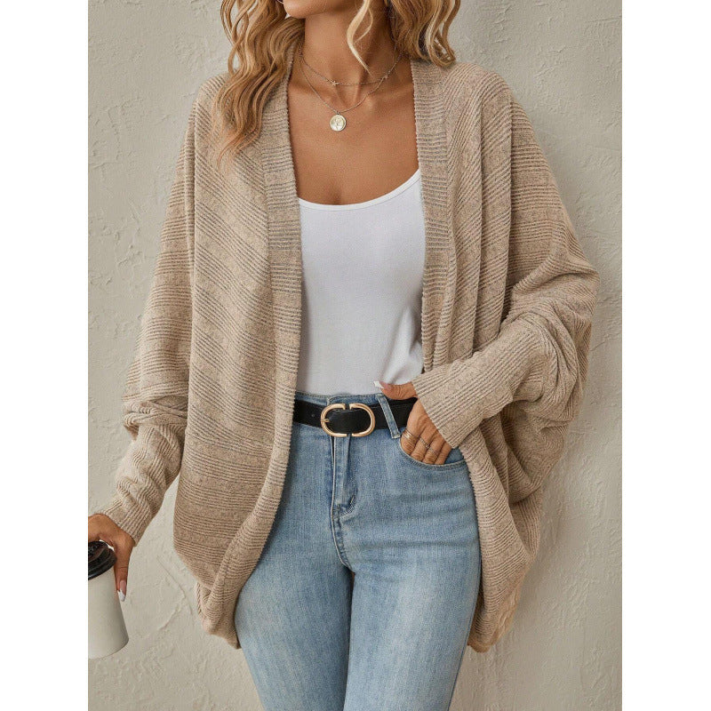 Beige oversized open front cardigan styled with a white tank and jeans