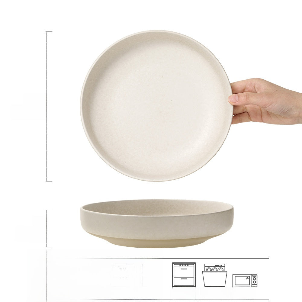 Hand holding a flat Japanese retro ceramic dinner plate in solid frost flower white glaze, with a smaller plate below for size comparison.