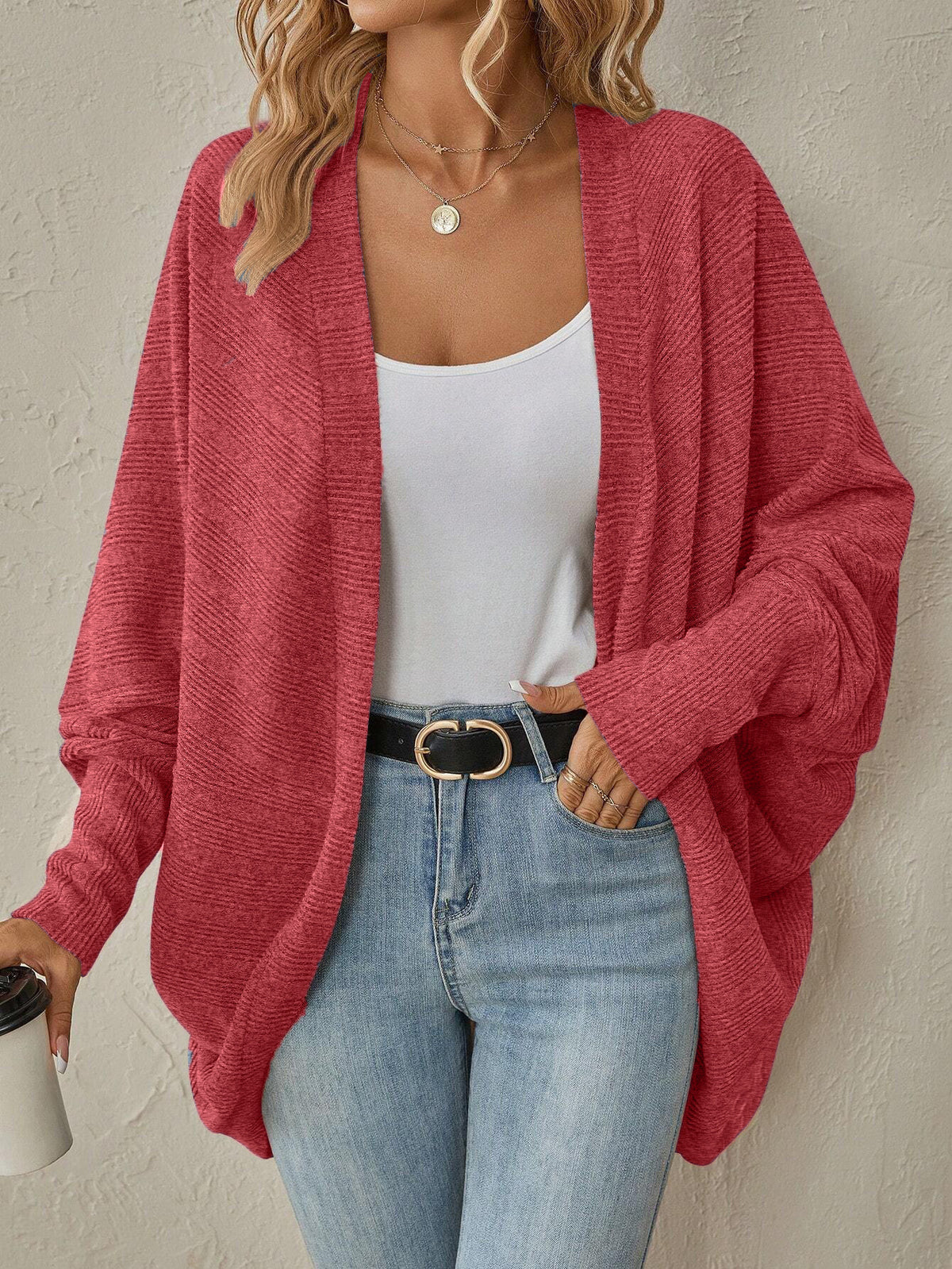 Front view of the orange red knit cardigan with long dolman sleeves