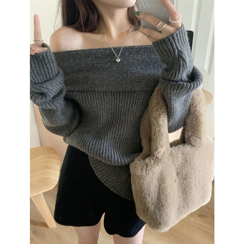 Dark gray off the shoulder fold over sweater with black shorts and a beige faux fur handbag