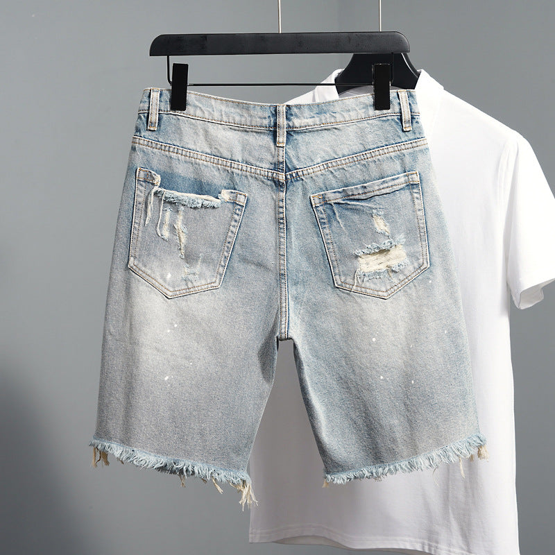 Men's ripped jean shorts close-up front pocket detail