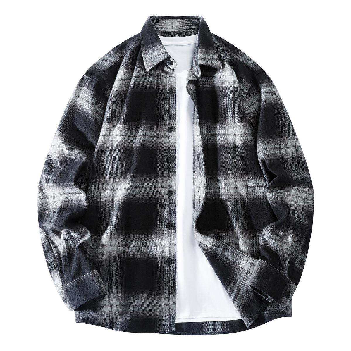 Model wearing black and white plaid flannel shirt open over a white tee