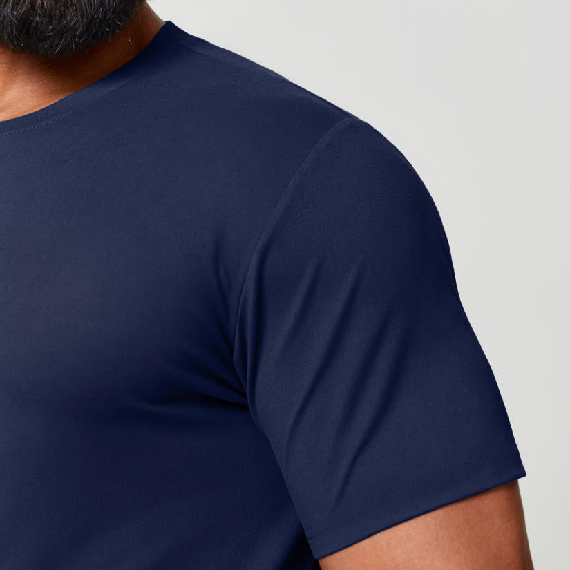 Close-up of navy blue moisture-wicking t-shirt fabric and shoulder seam