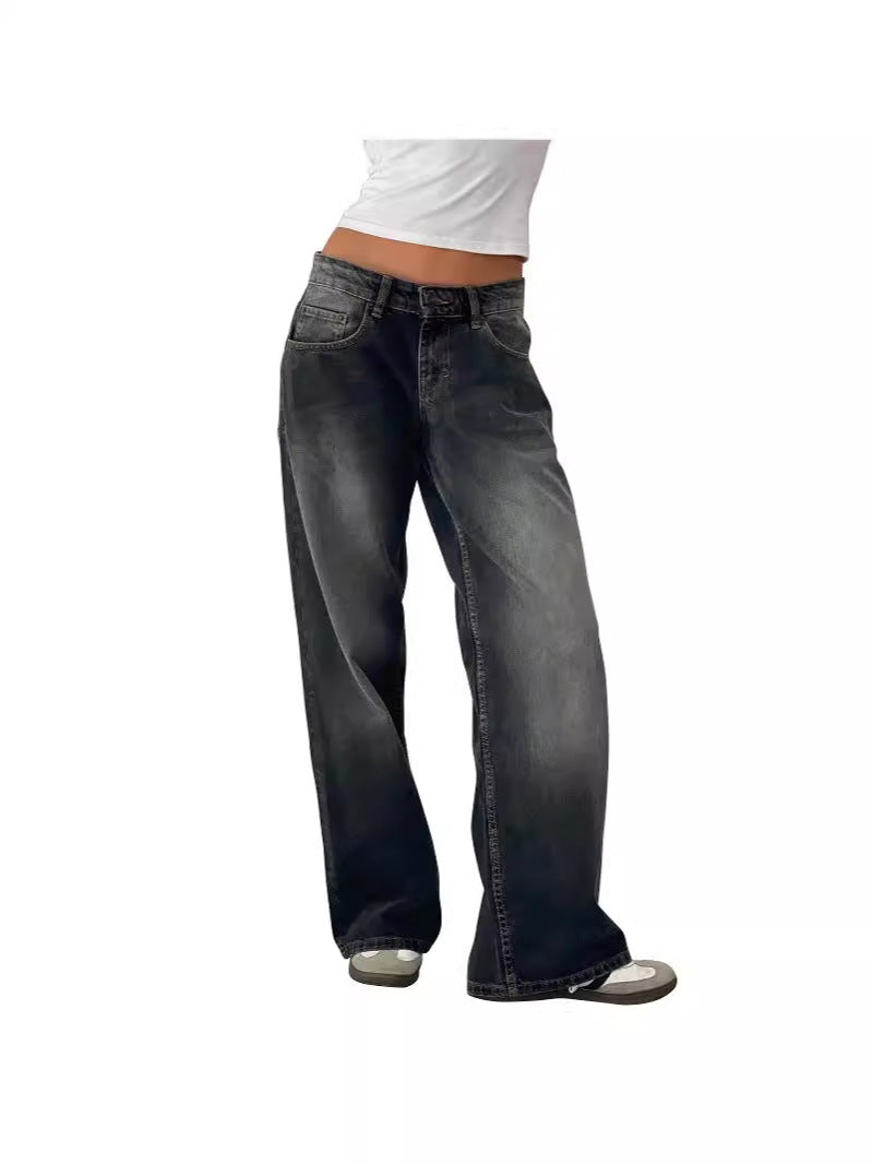 Woman wearing high-waisted black faded straight-leg jeans with white crop top, front view, slight angle.