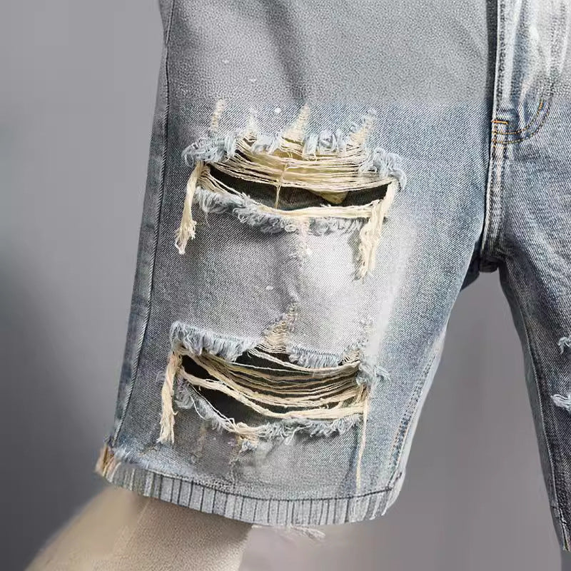 Men's ripped denim shorts heavy distressing close-up