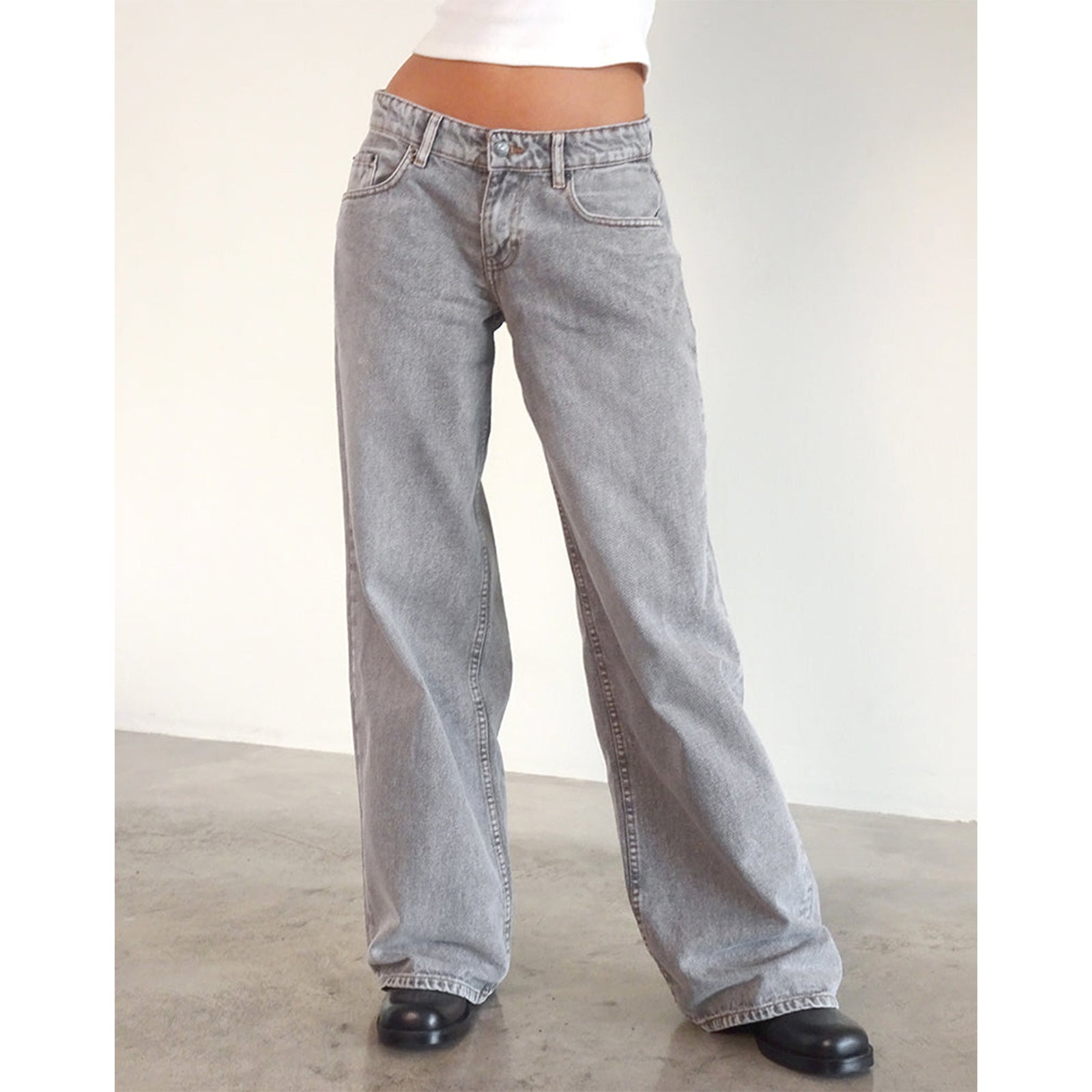 Woman in light gray high-waisted straight-leg wide jeans with black shoes, front view.