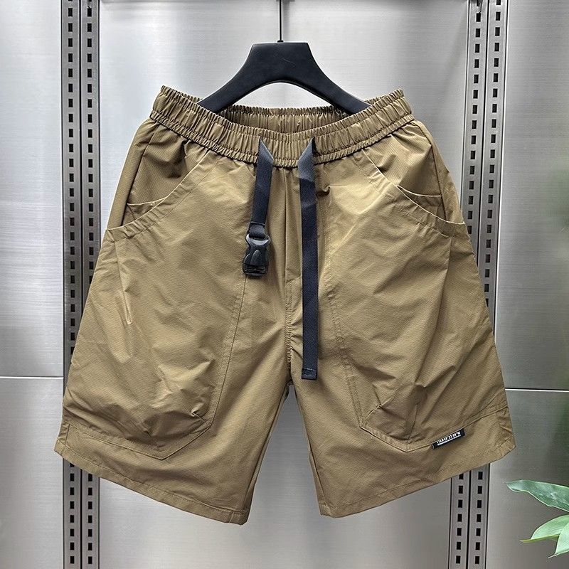 Khaki/tan cargo shorts with black drawstring and flap pockets.